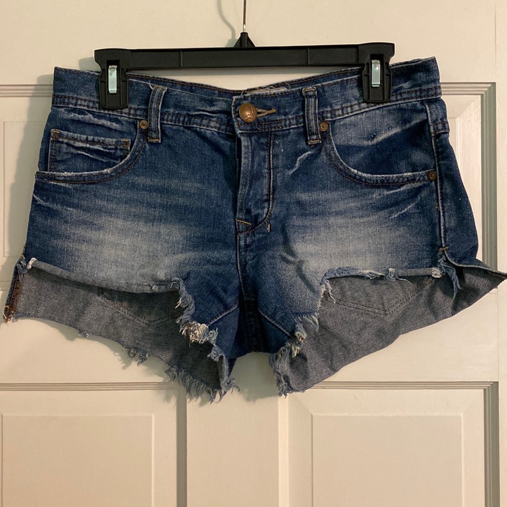 Size 25 Free People denim high-low cut off shorts.